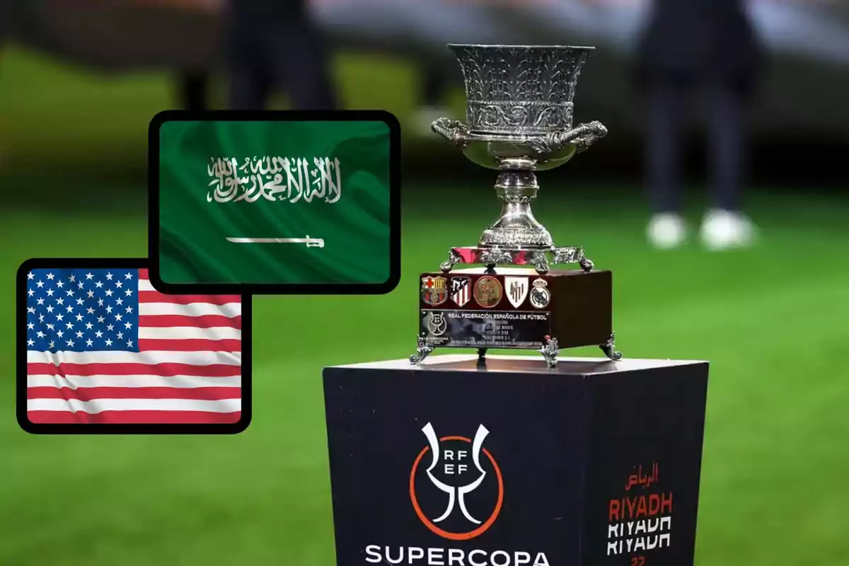 Trofeo de la Supercopa de España sobre un pedestal con las banderas de Arabia Saudita y Estados Unidos al fondo