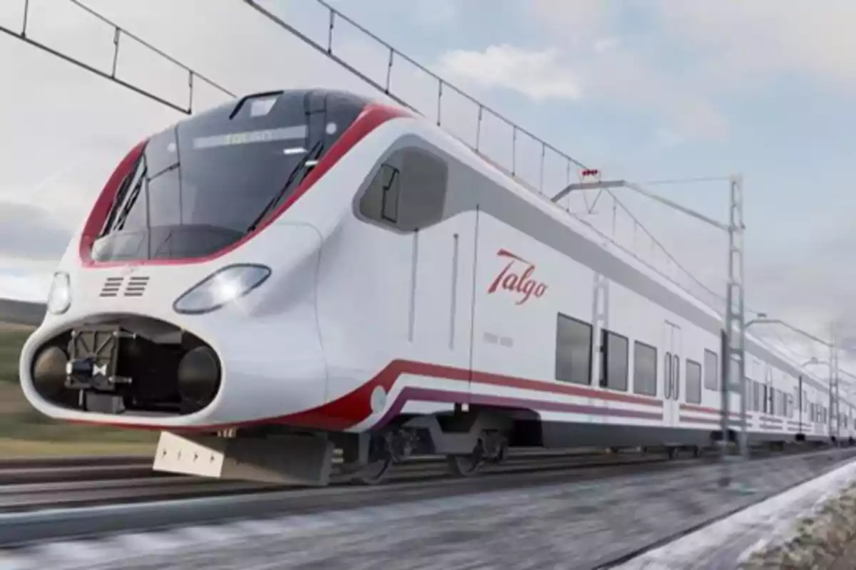 Un tren de alta velocidad blanco y rojo de la marca Talgo circulando por una vía electrificada.