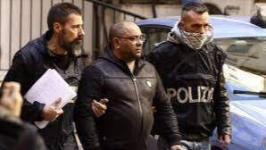 Dos agentes de policía arrestan a Carmine Spada, uno de los jefes de la mafia italiana.