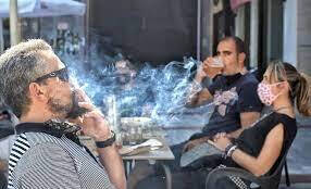 Gente fumando en una terraza